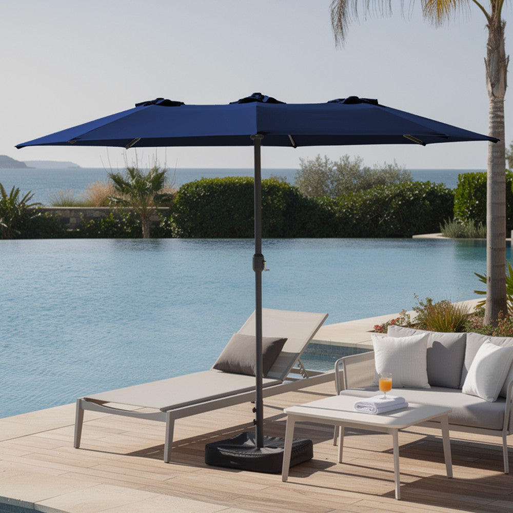 Blue double garden parasol providing shade beside a swimming pool with sun loungers