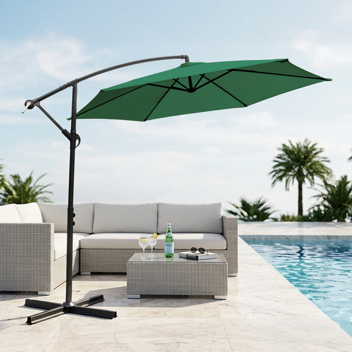 Green 3m cantilever garden parasol providing shade beside a swimming pool with rattan outdoor sofa set