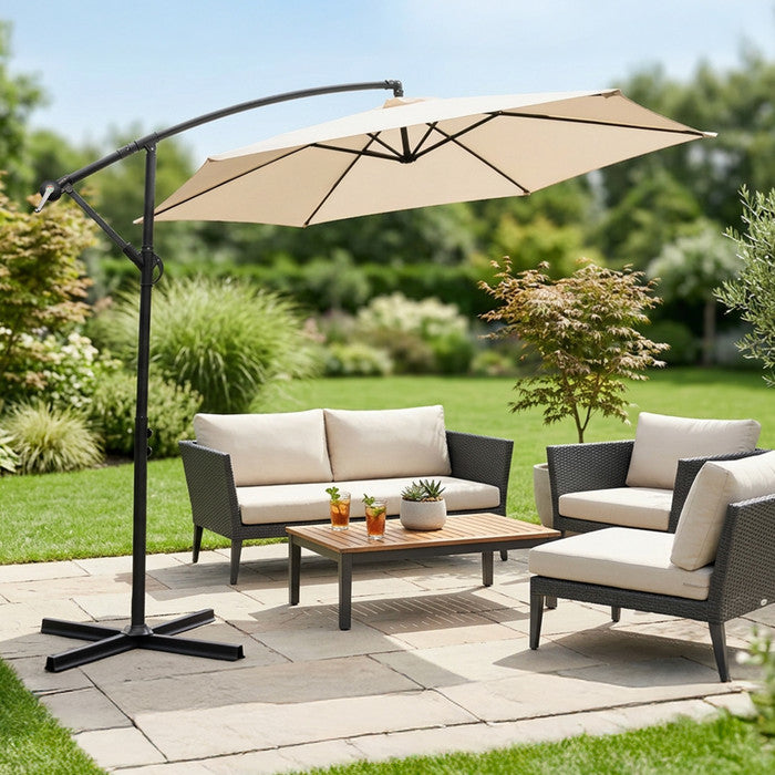 Cream 3m cantilever garden parasol over rattan garden lounge set on a patio with lush garden backdrop