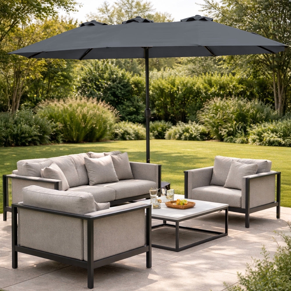 Grey double garden parasol providing shade beside a swimming pool with sun loungers